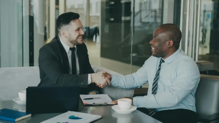 Businessmen Shaking Hands at Meeting